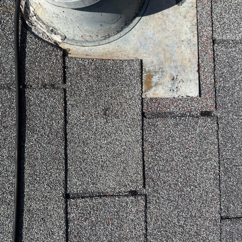 Asphalt roof shingles around metal vent pipe flashing Asphalt roof shingles around metal vent pipe flashing