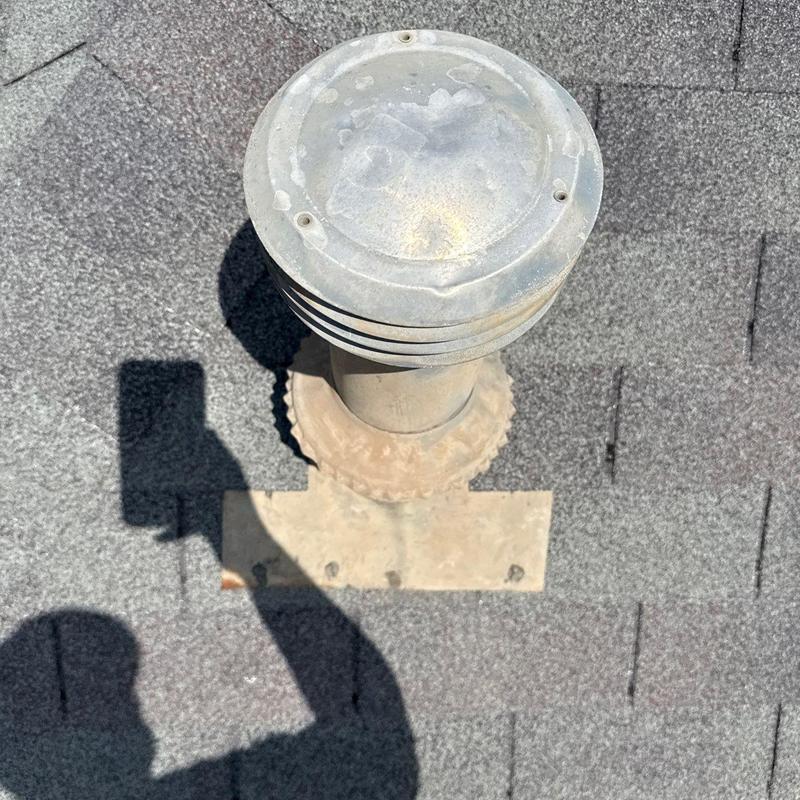 Roof vent pipe with metal cap on asphalt shingles Roof vent pipe with metal cap on asphalt shingles