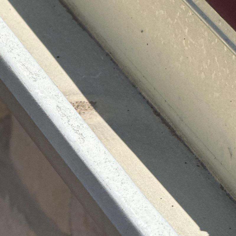 Window sill and frame close-up with minor dirt and wear Window sill and frame close-up with minor dirt and wear