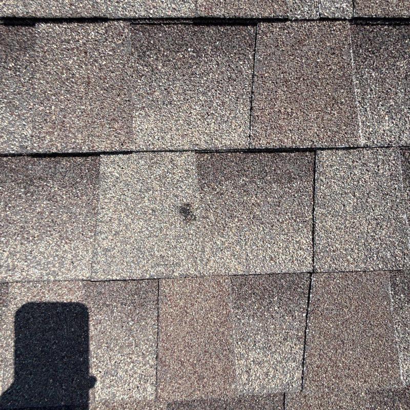 Shingle roof with hail damage spot and repairs Shingle roof with hail damage spot and repairs