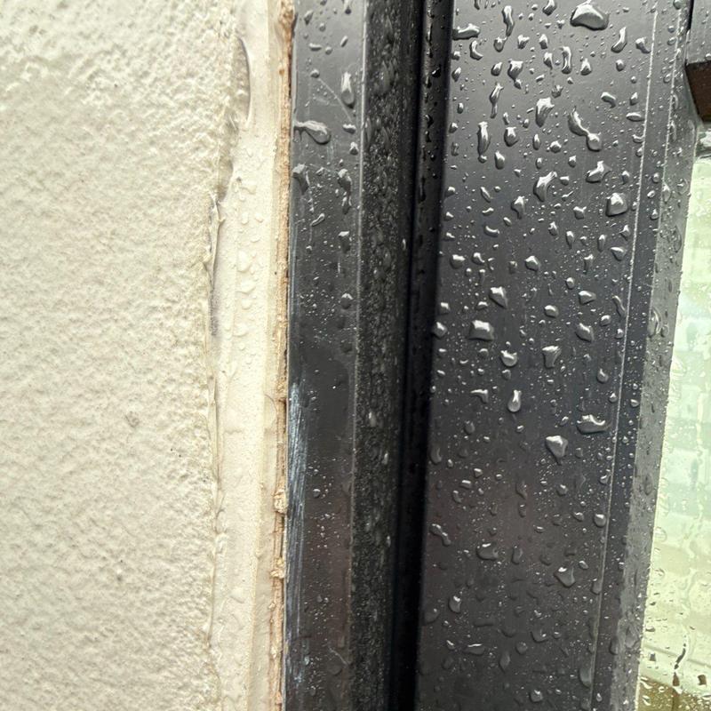Window frame sealing with water droplets on glass Window frame sealing with water droplets on glass
