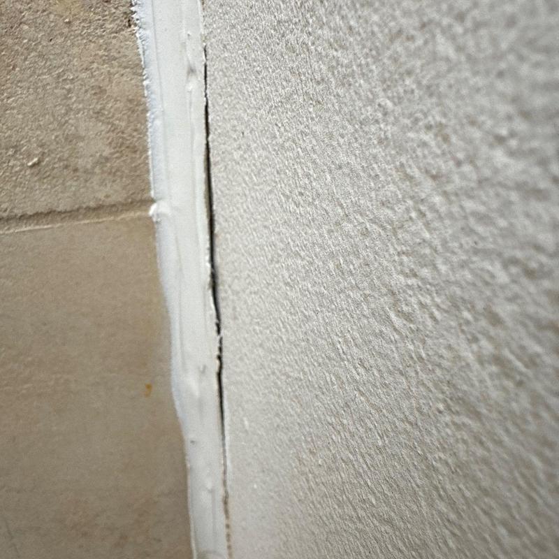 Stucco wall crack with patching and sealant Stucco wall crack with patching and sealant