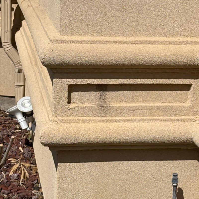 Stucco wall surface with minor discoloration stain Stucco wall surface with minor discoloration stain
