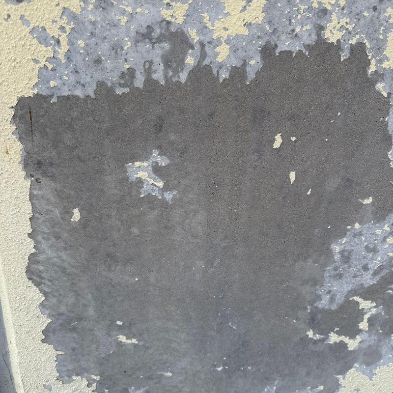 Concrete stucco wall with paint peeling and damage Concrete stucco wall with paint peeling and damage