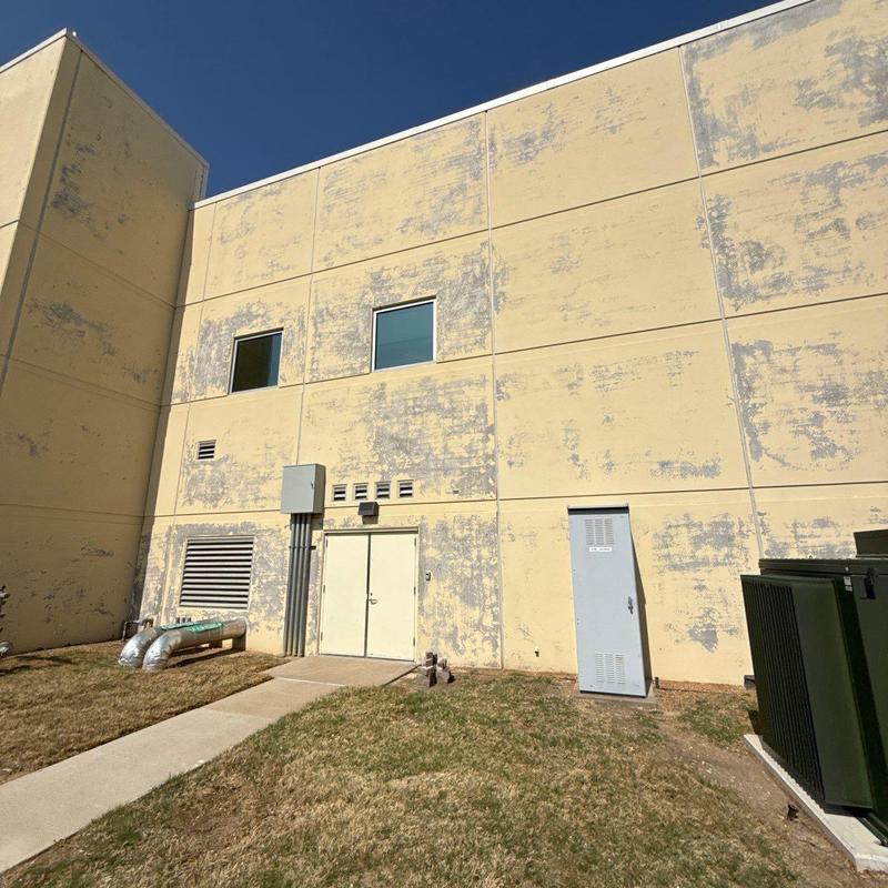 Exterior stucco wall with significant paint peeling Exterior stucco wall with significant paint peeling