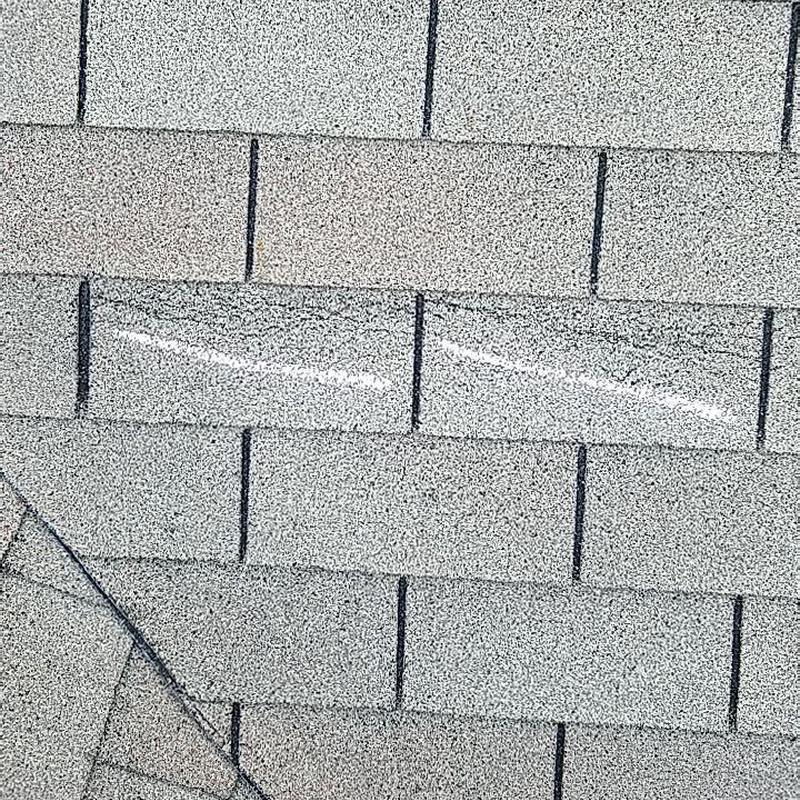Asphalt shingle roof close-up with new granules