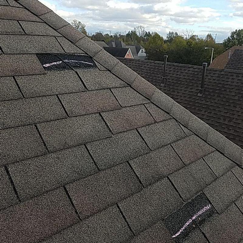 Asphalt shingle roof with marked hail damage