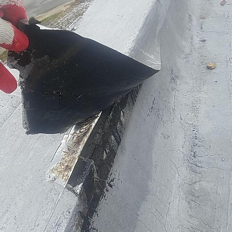 Concrete commercial roof membrane peeling with hail damage