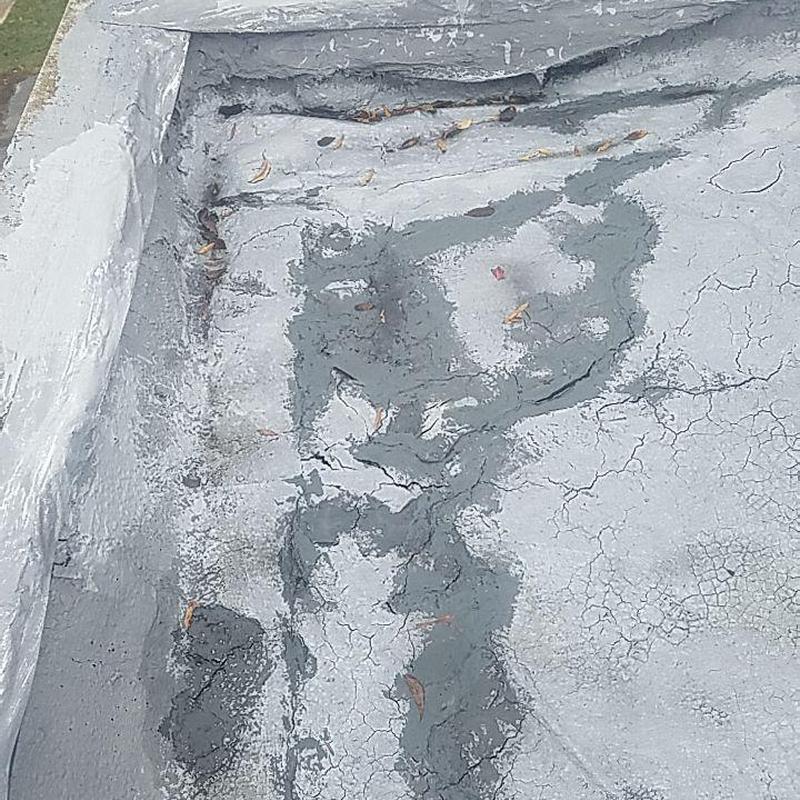 Concrete flat roof patch with sealant and cracks