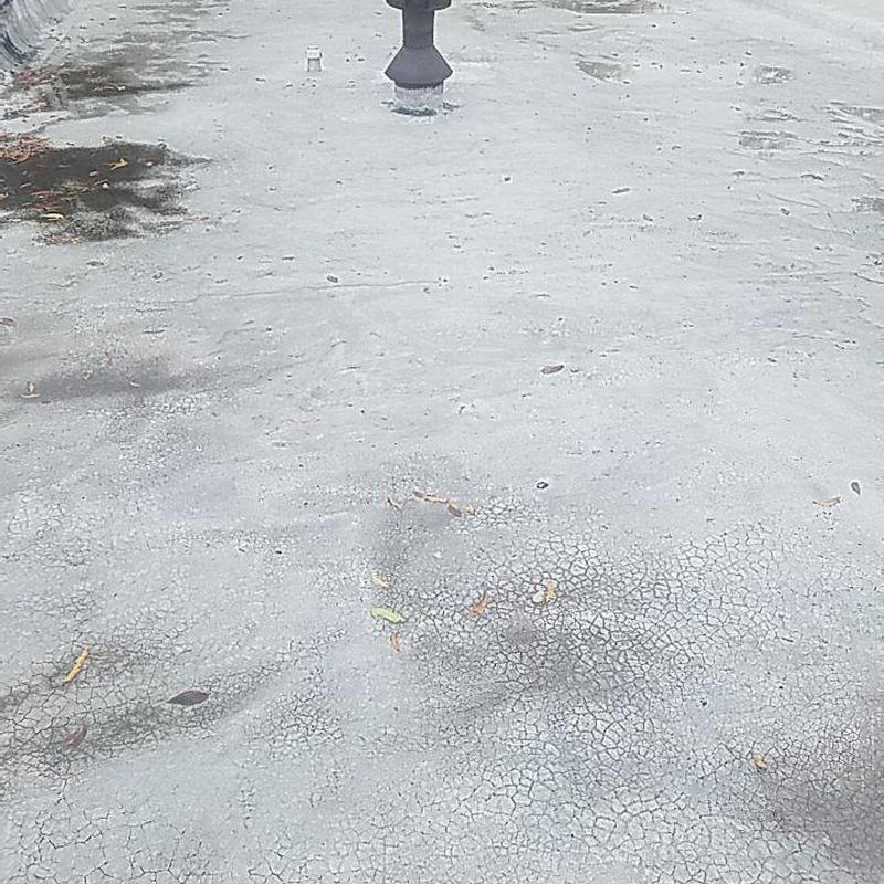 Concrete commercial roof with hail and storm damage