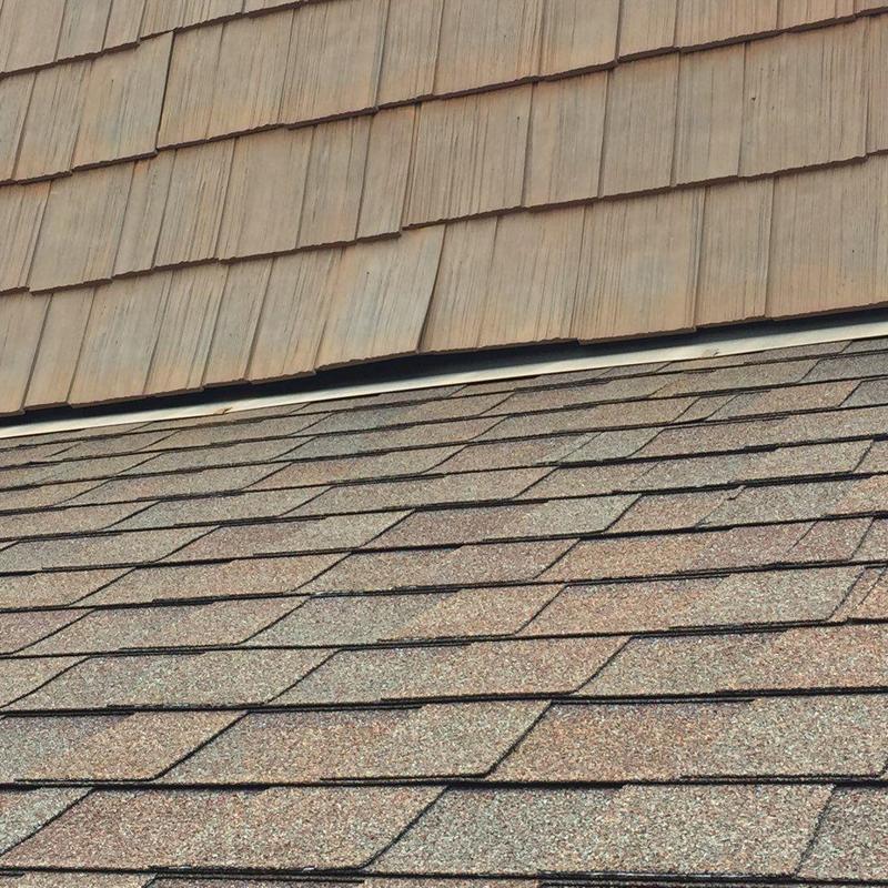 Asphalt shingle roof with new installation near siding