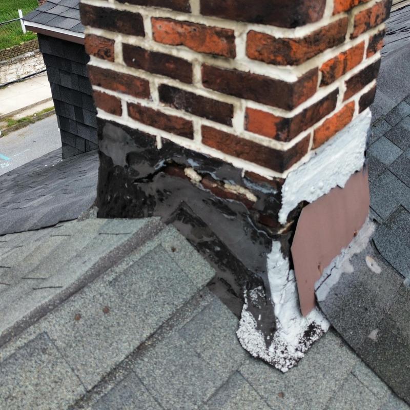 Chimney flashing with damaged roofing sealant Chimney flashing with damaged roofing sealant