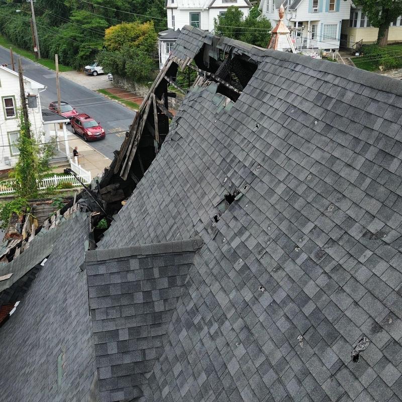Asphalt shingle roof with extensive fire damage and holes Asphalt shingle roof with extensive fire damage and holes
