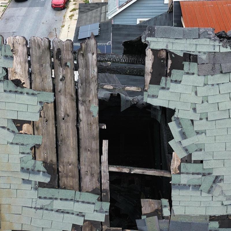Roof decking fire damage with missing shingles Roof decking fire damage with missing shingles