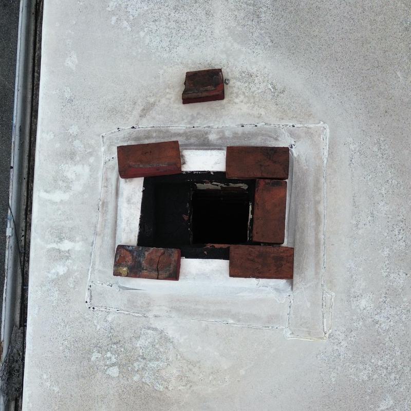 EPDM roof vent with loose bricks and damaged sealant EPDM roof vent with loose bricks and damaged sealant