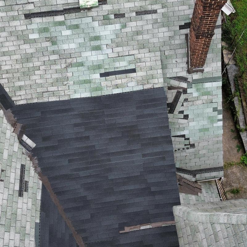Asphalt shingle roof with wind damage and patch repairs Asphalt shingle roof with wind damage and patch repairs