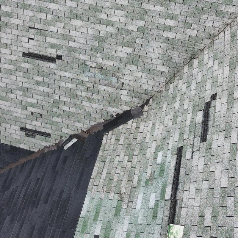 Asphalt shingles with wind damage and previous repairs Asphalt shingles with wind damage and previous repairs