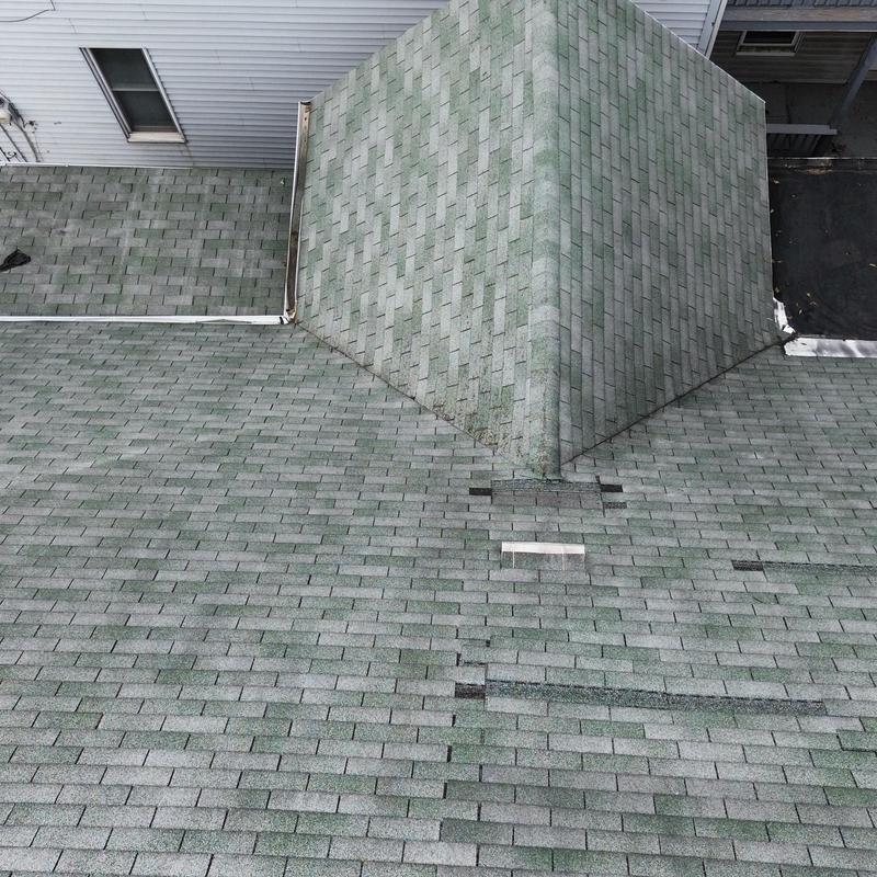 Asphalt shingle roof with overlapping previous repairs Asphalt shingle roof with overlapping previous repairs