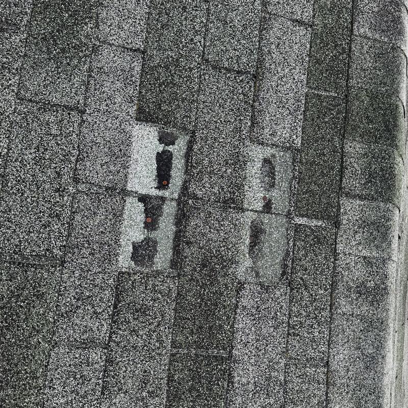 Asphalt shingles with missing granules and exposed nails Asphalt shingles with missing granules and exposed nails