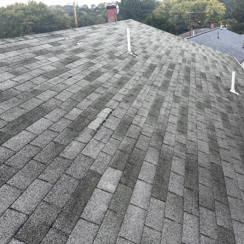 Asphalt shingle roof with patched shingles and vents Asphalt shingle roof with patched shingles and vents