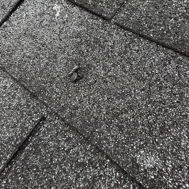 Asphalt roofing shingles with loose nail head Asphalt roofing shingles with loose nail head