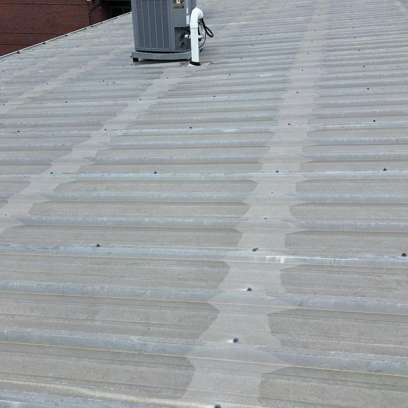 Commercial metal roof with rubber grommets on HVAC unit Commercial metal roof with rubber grommets on HVAC unit