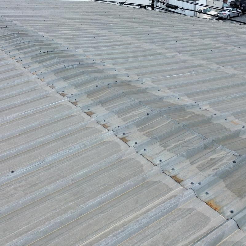 Metal roof panels with visible rust and grommets Metal roof panels with visible rust and grommets