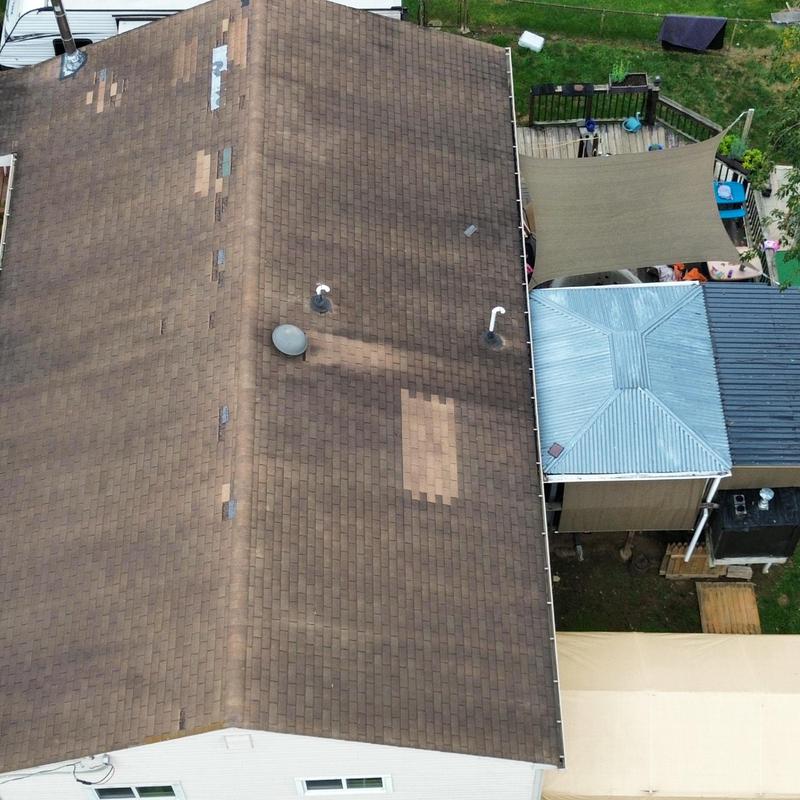 Asphalt shingle roof with wind damage and repairs Asphalt shingle roof with wind damage and repairs