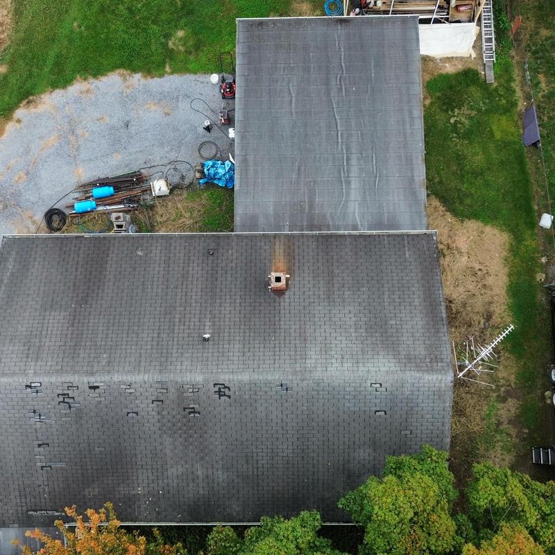 Asphalt shingle roof with missing shingles and wear Asphalt shingle roof with missing shingles and wear
