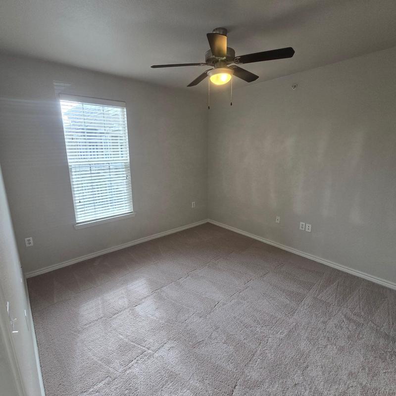 Ceiling fan with light fixture in empty room Ceiling fan with light fixture in empty room