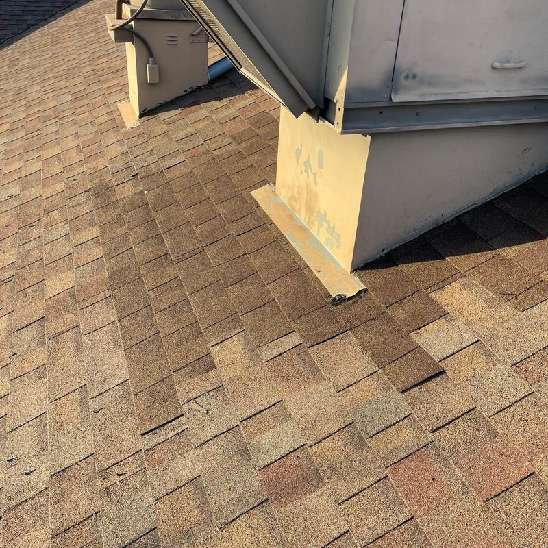 Shingle roof with metal flashing near vent structure Shingle roof with metal flashing near vent structure