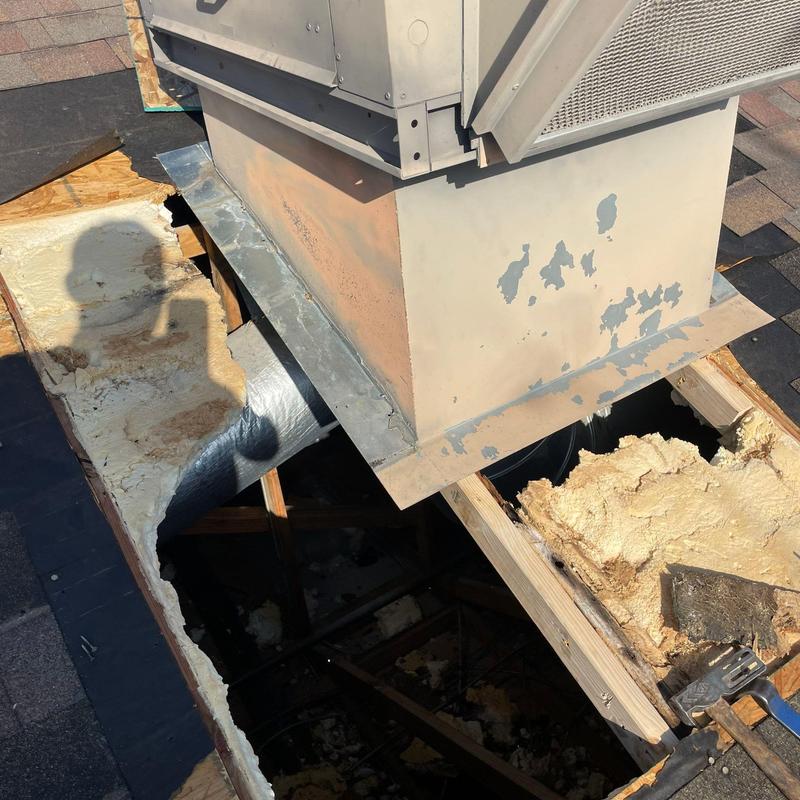 Rooftop HVAC unit with damaged shingle roof framing Rooftop HVAC unit with damaged shingle roof framing