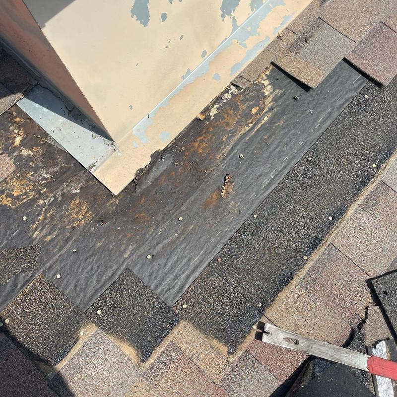 Shingle roof leak area with exposed underlayment and flashing Shingle roof leak area with exposed underlayment and flashing