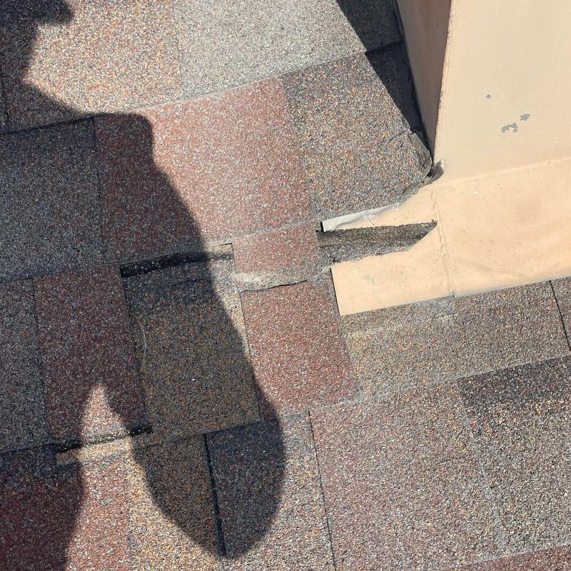 Hail-damaged shingle roof near chimney flashing repair Hail-damaged shingle roof near chimney flashing repair