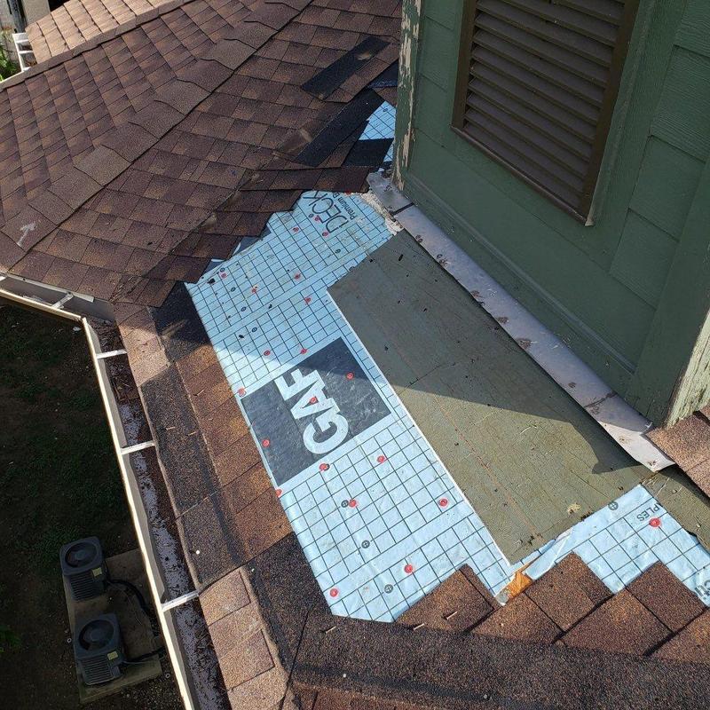 Shingle roof with underlayment repair near vent wall Shingle roof with underlayment repair near vent wall