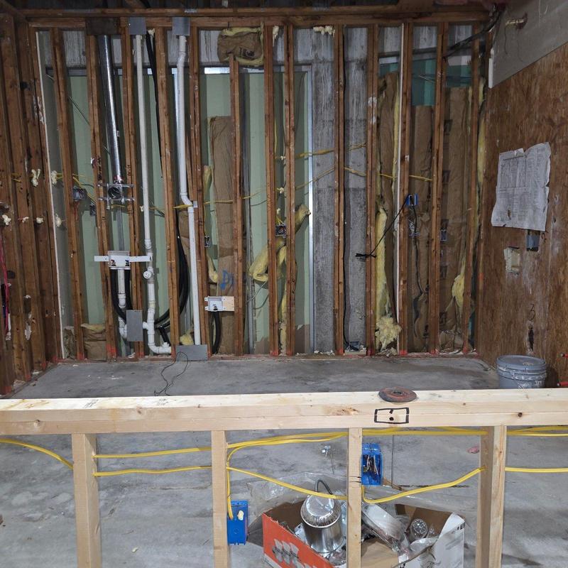 Exposed wall framing with plumbing and electrical rough-in Exposed wall framing with plumbing and electrical rough-in