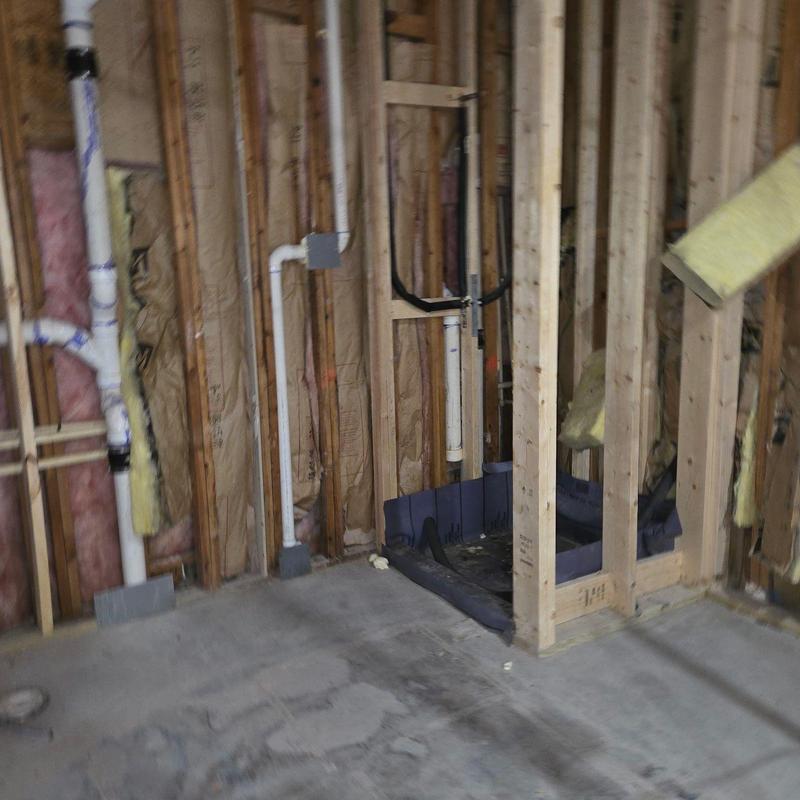 Bathroom plumbing rough-in with wood framing and insulation Bathroom plumbing rough-in with wood framing and insulation