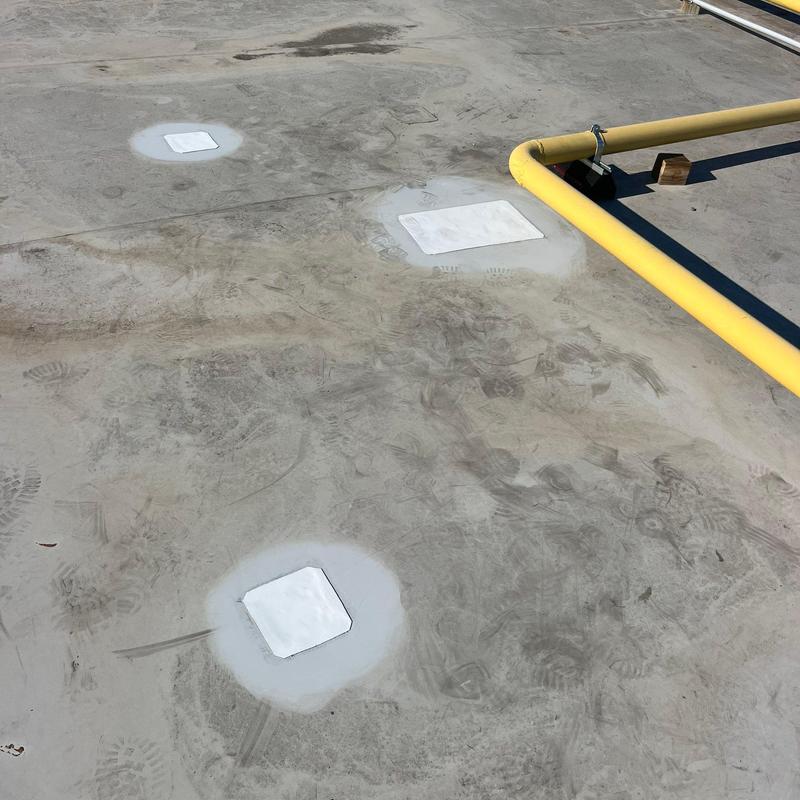 Concrete roof patching with waterproof coating and yellow gas pipe Concrete roof patching with waterproof coating and yellow gas pipe