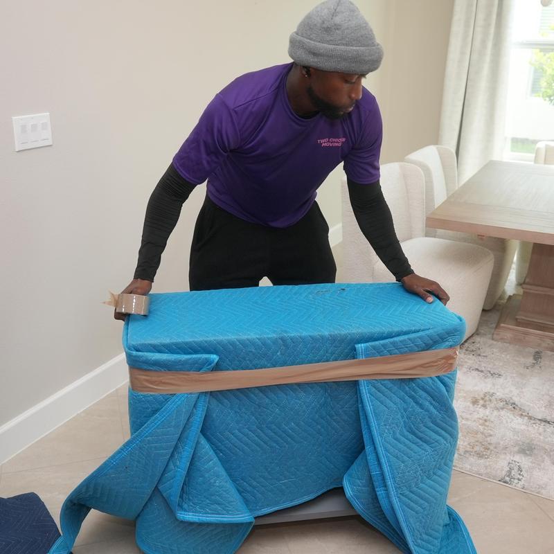 Furniture wrapped with moving blanket and tape