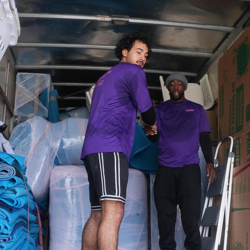 Furniture wrapped for moving inside truck with movers