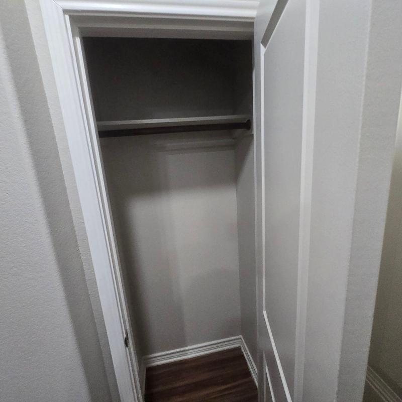 Closet interior with shelf and hanging rod Closet interior with shelf and hanging rod