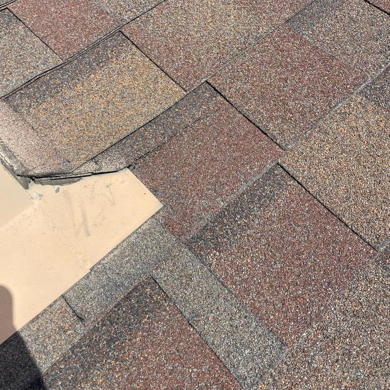 Hail-damaged shingle roof with corner flashing repair Hail-damaged shingle roof with corner flashing repair