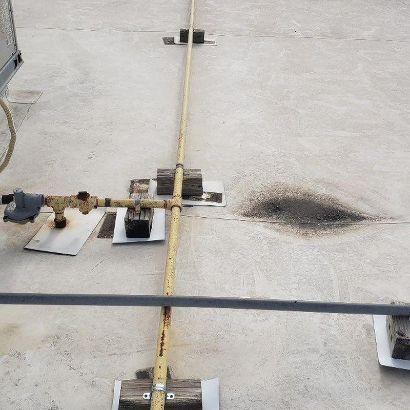 Concrete roof with hail damage and gas pipes Concrete roof with hail damage and gas pipes