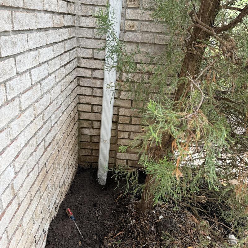Lender line drainage pipe near brick house corner Lender line drainage pipe near brick house corner