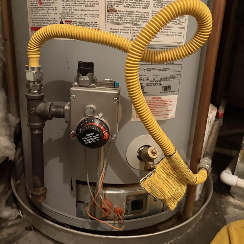 Water heater with regulator and yellow flex gas line