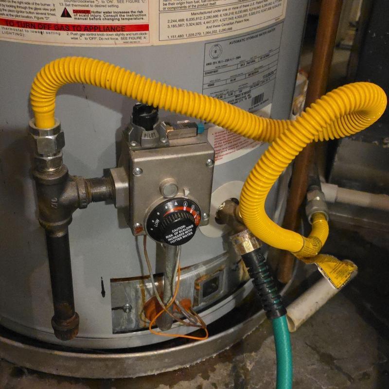 Water heater thermostat and flex gas line connection