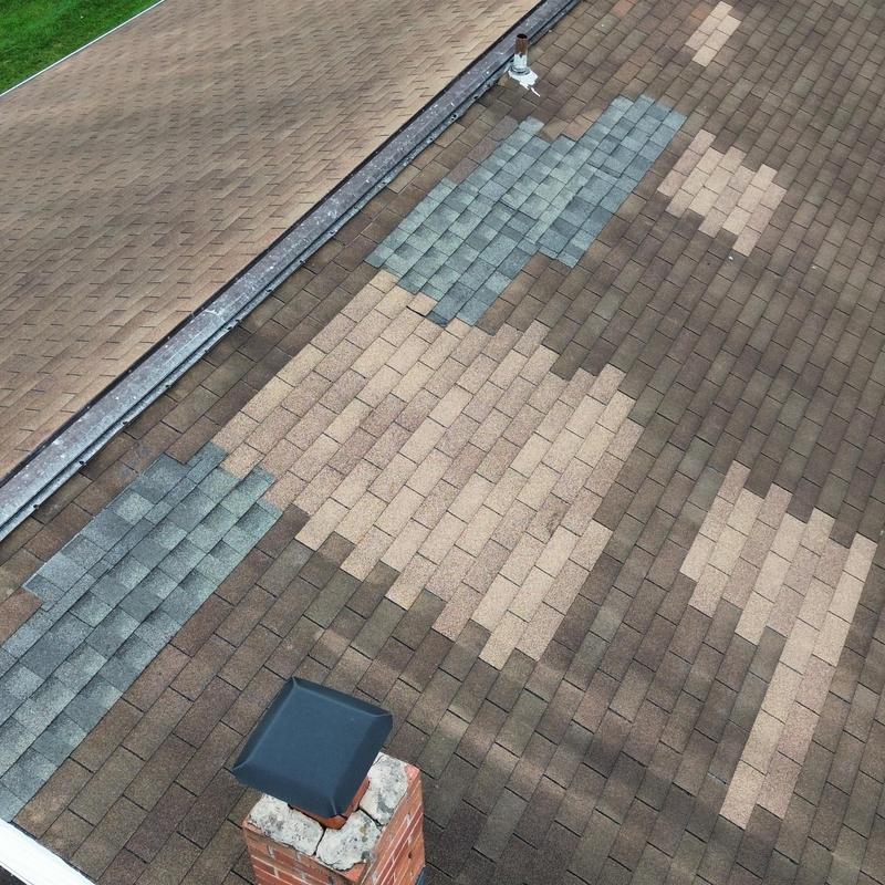 Asphalt shingle roof with patch repairs on apartment building Asphalt shingle roof with patch repairs on apartment building