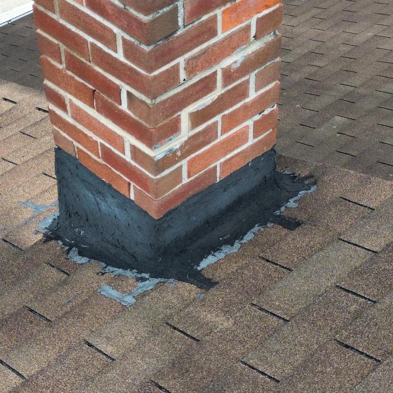Chimney base flashing on asphalt shingle roof Chimney base flashing on asphalt shingle roof