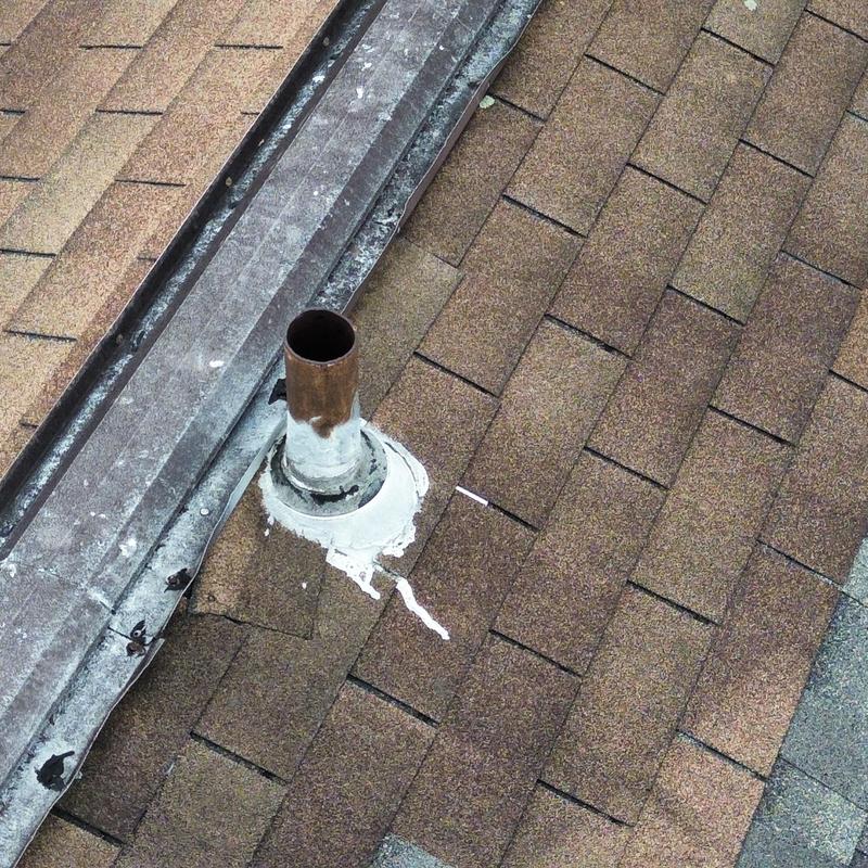 Asphalt shingle roof with damaged vent pipe flashing Asphalt shingle roof with damaged vent pipe flashing