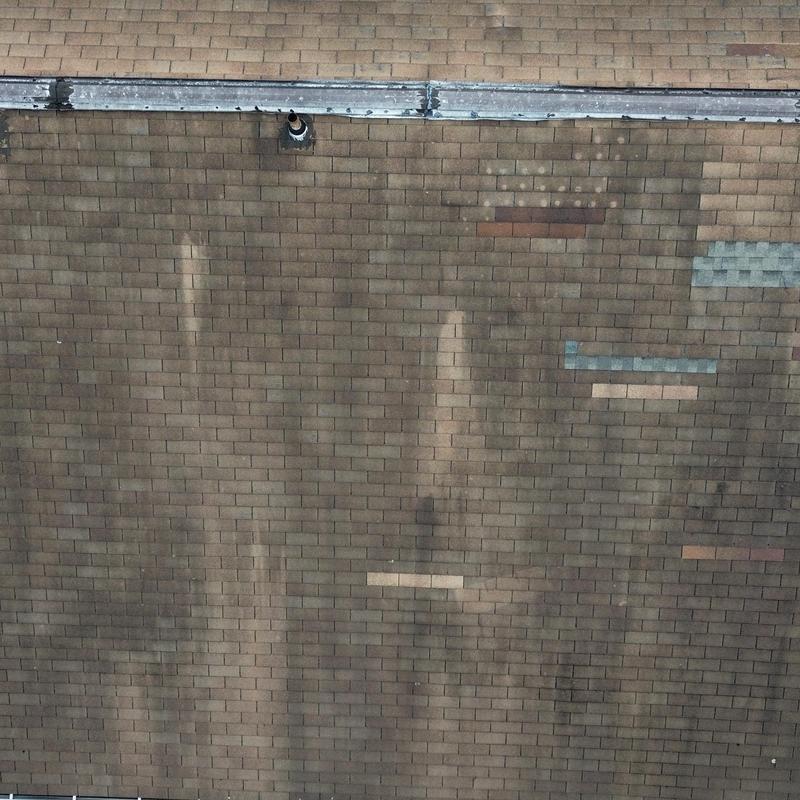Asphalt shingle roof with patch repairs and wear Asphalt shingle roof with patch repairs and wear
